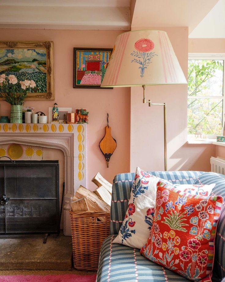 a living room filled with furniture and a fire place next to a painting on the wall