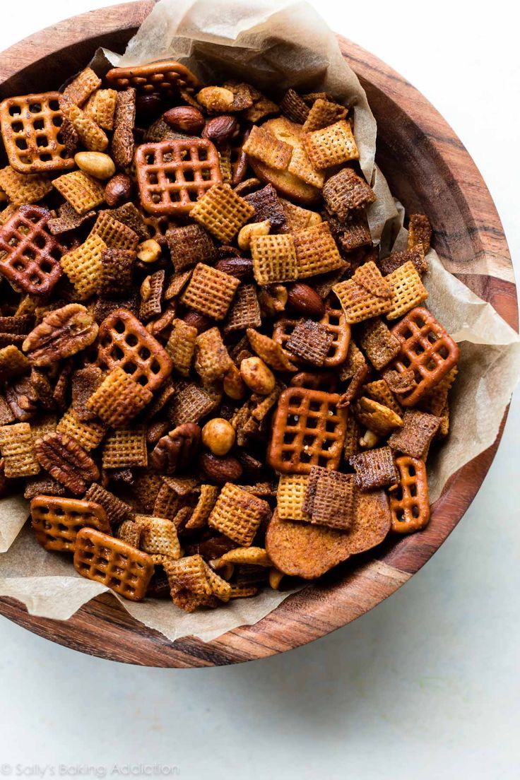 a wooden bowl filled with waffles and nuts