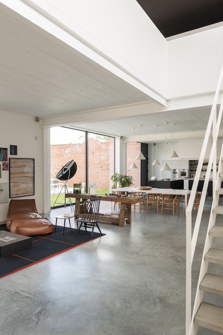 an open living room and dining area with stairs