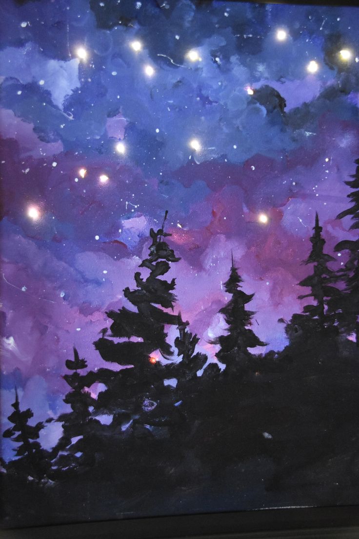 the painting is hanging on the wall in front of the orange wall and there are stars above the trees