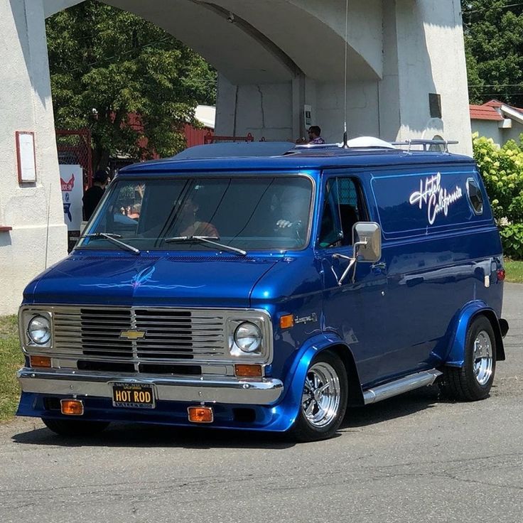 a blue van parked in front of a building