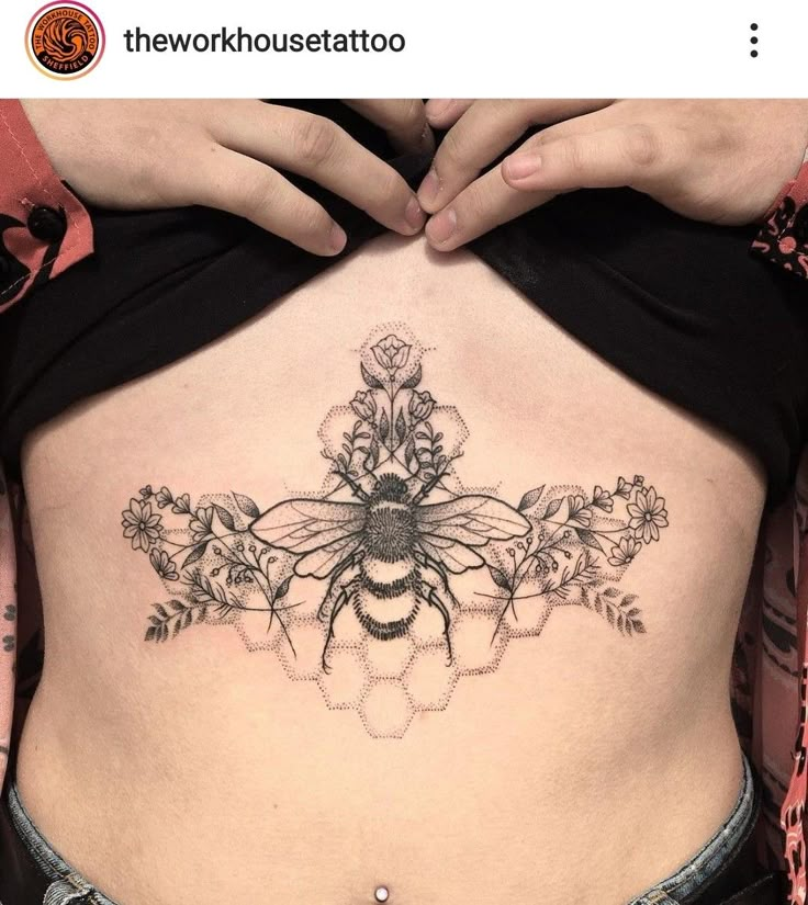 a woman with a bee tattoo on her stomach