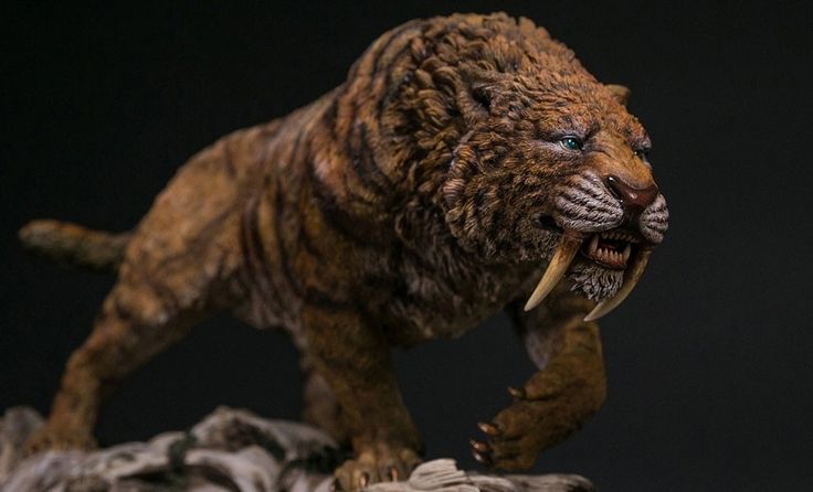 a close up of a figurine of a lion on a rock with it's mouth open