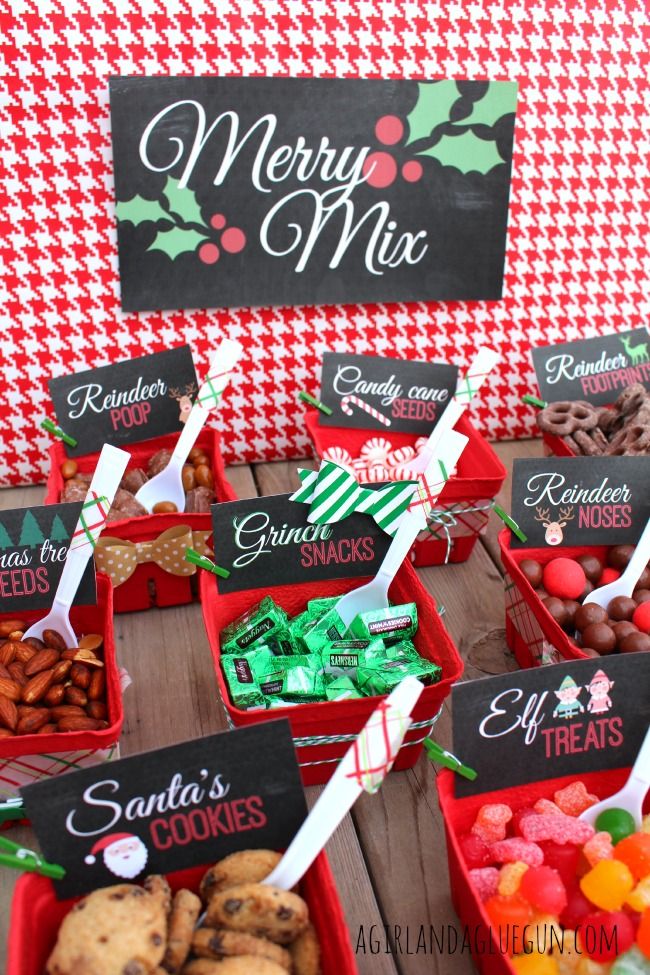 a table topped with red baskets filled with candy and candies next to a merry mix sign