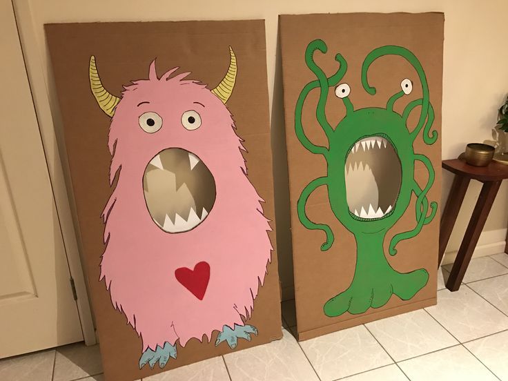 two cardboard monsters with mouths and teeth on them