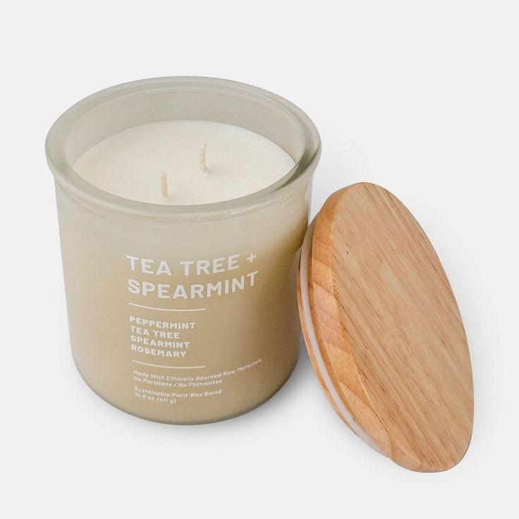 a tea tree and spearmint candle next to a wooden lid