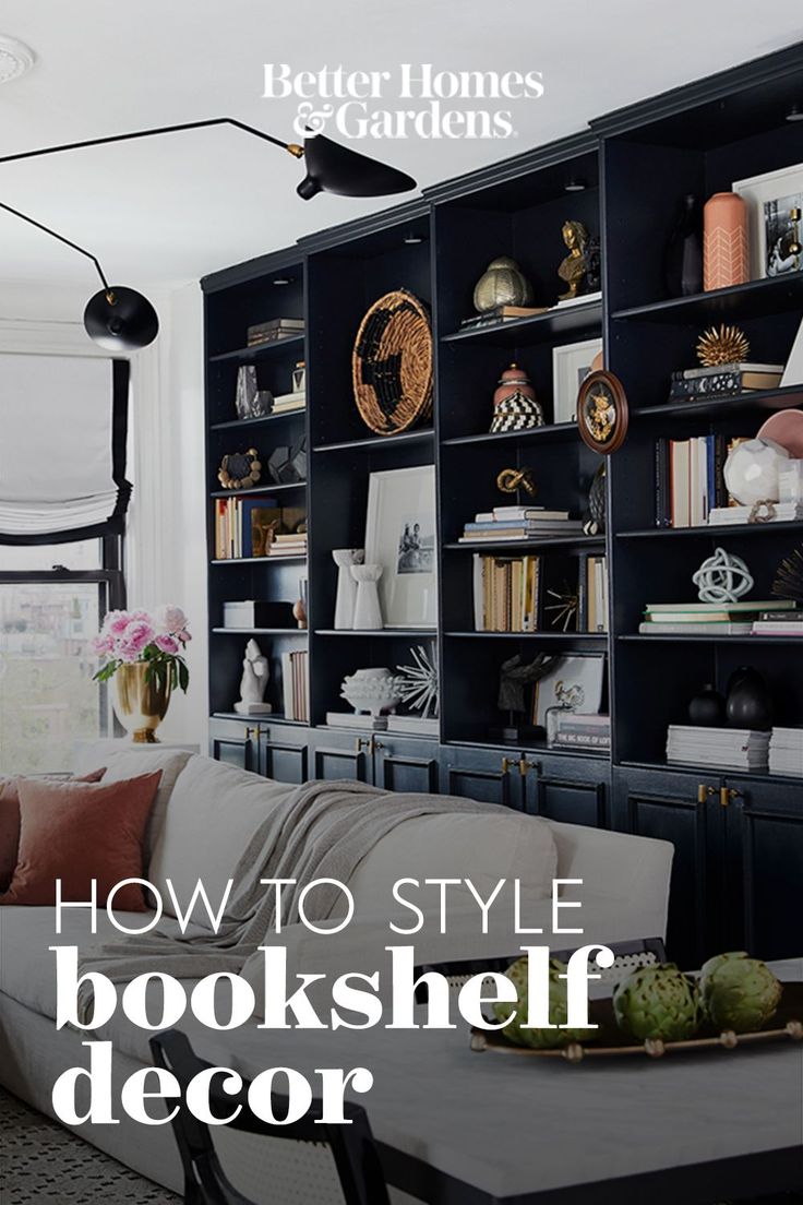 a living room filled with furniture and bookshelves next to a wall mounted bookcase