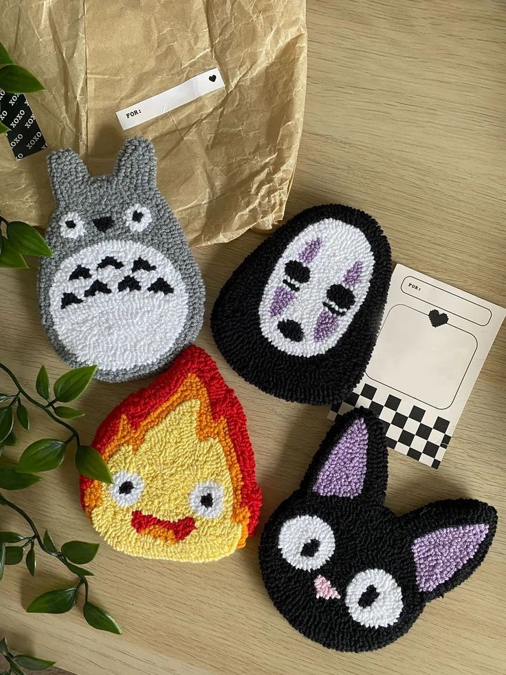 three crocheted animal coin purses sitting on top of a table