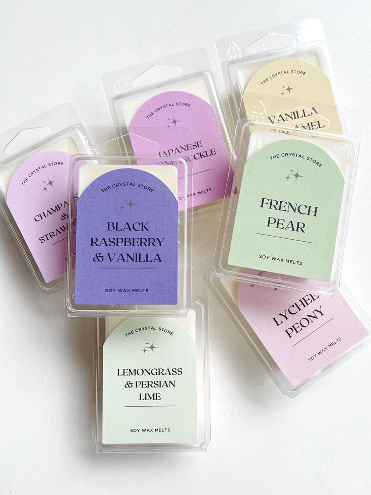 four different types of soaps in plastic cases on a white surface, with the label labeled fresh raspberry and vanilla