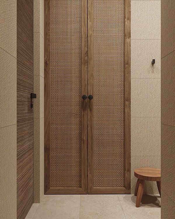 a wooden door in a bathroom next to a bench