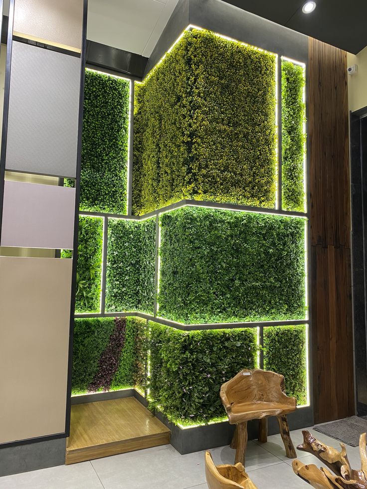 a living room with green plants on the wall and a wooden bench in front of it