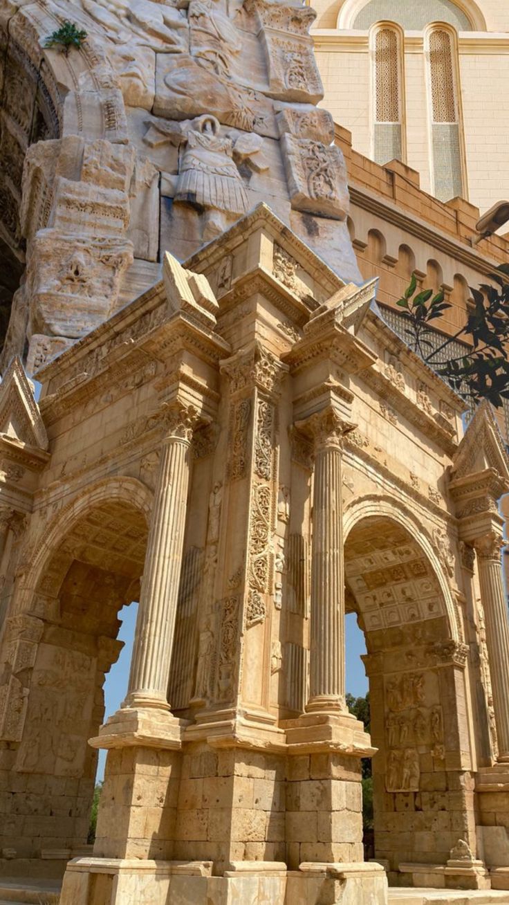 an old building with statues on the front