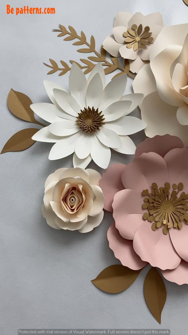 paper flowers are arranged on a gray surface