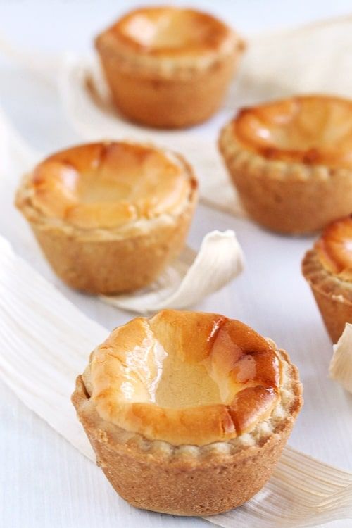 several small pies sitting on top of a white plate