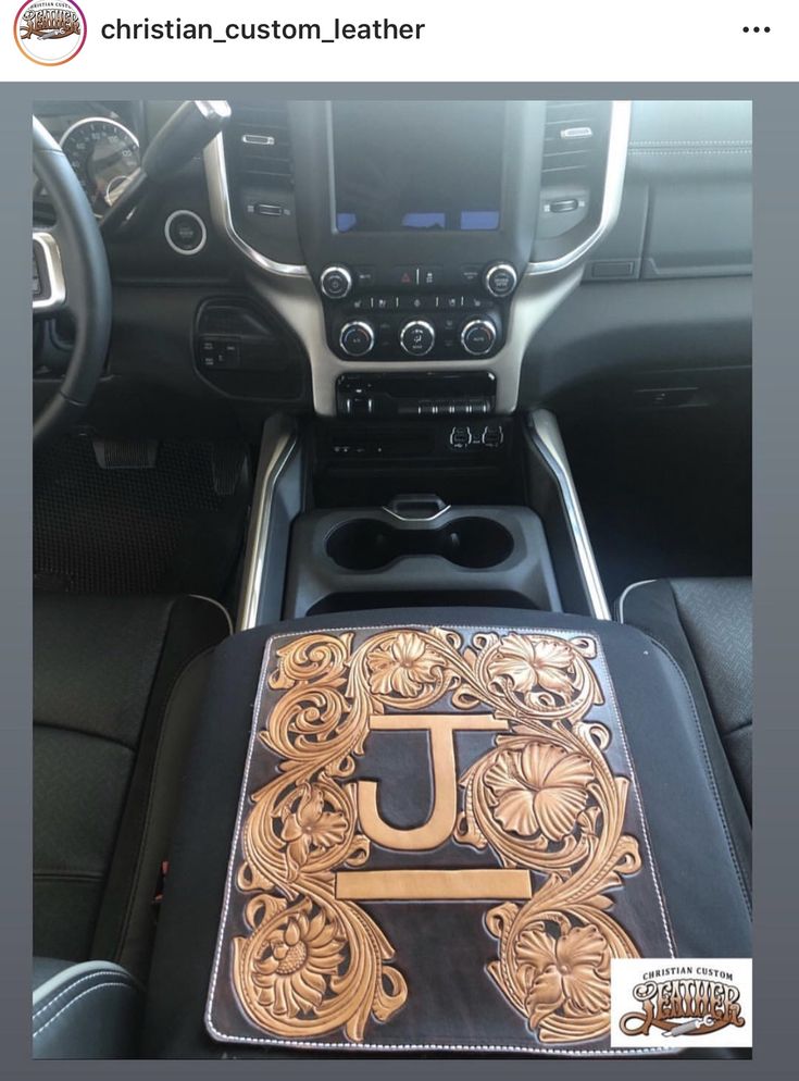 the interior of a car with an intricately decorated book on it's center console