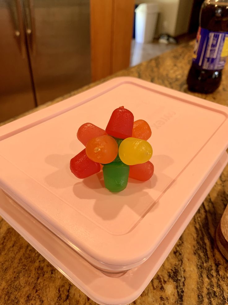 there are gummy bears sitting on top of the plastic trays in the kitchen