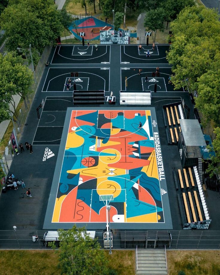 an aerial view of a basketball court in the park