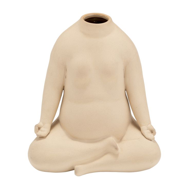 a statue of a person sitting in a yoga position