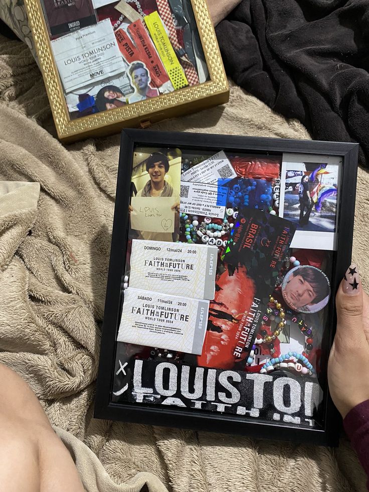 a person is laying on a bed with their feet propped up next to a framed photo