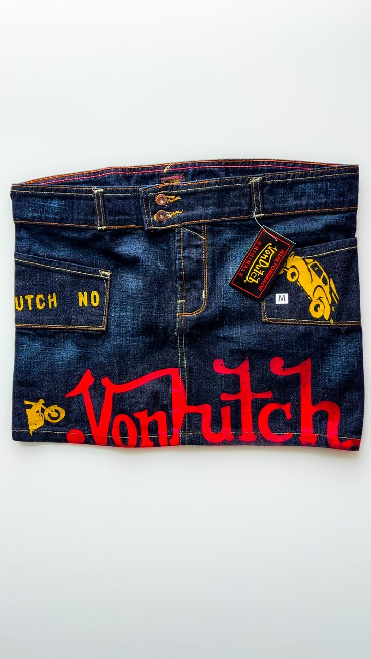 Vintage Von Dutch Mini Skirt. This Denim skirt has the 'kustomised' tag attached, in Size M & L. It breathes the 90's era with the ionic brand printed on the skirt with motorcycles and cars with lettering at the back of the skirt.  This skirt is discontinued and rare in such condition so its a perfect gift or a treat for yourself! Von Dutch Outfit, Von Dutch Skirt, Nessa Concert, Von Dutch Jeans, 90’s Hiphop Fashion, Retro Denim Mini Skirt, Von Dutch Clothes, Von Dutch Mini Skirt, Vintage Denim Blue Mini Skirt