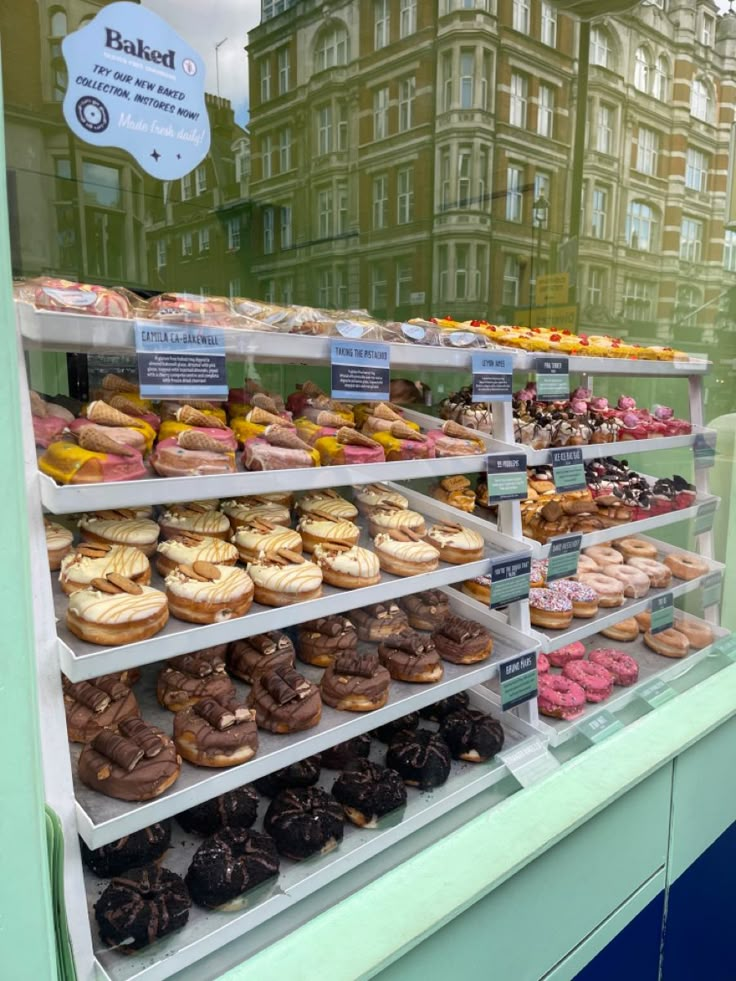 a display case filled with lots of different types of doughnuts and pastries