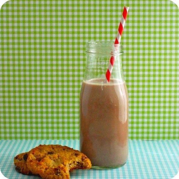 a cookie and milkshake sitting on a table next to a green checkered wall