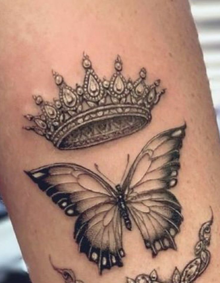 a butterfly with a tiara on it's head is shown in this tattoo design