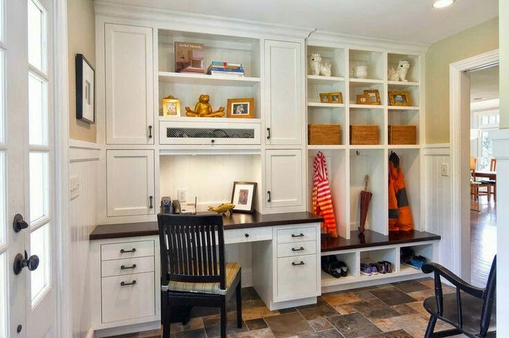 a room that has some white cabinets and black chairs in it with brown tile flooring