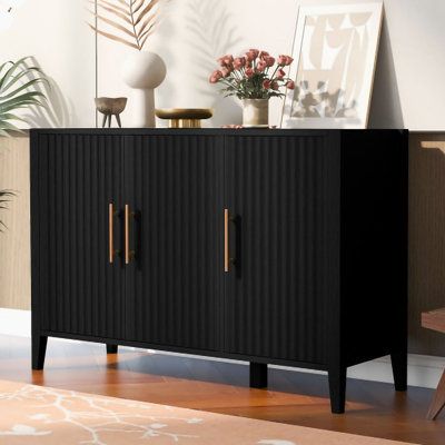 a black cabinet with brass handles in a living room