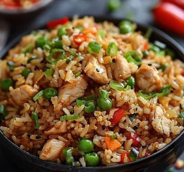 a black bowl filled with rice and vegetables