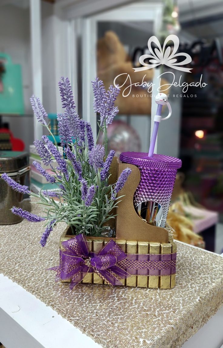 purple flowers are in a basket on top of a table