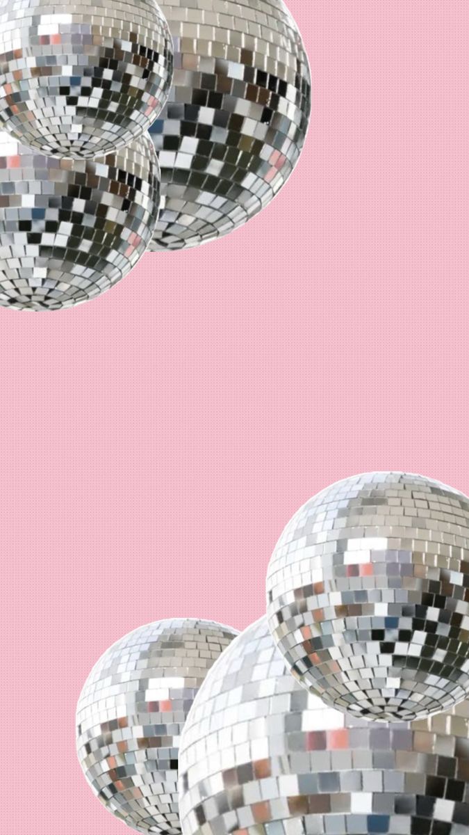 several shiny disco balls on a pink background