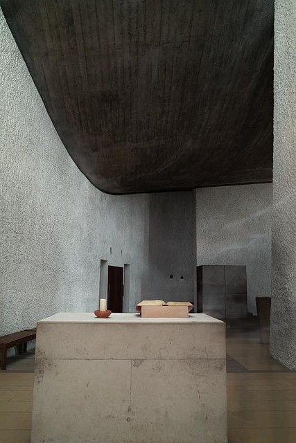 the interior of a modern building with concrete walls