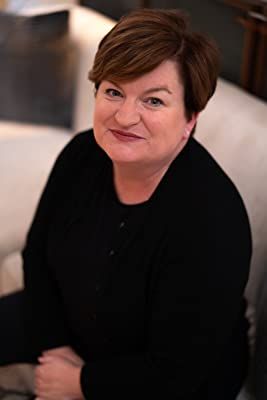 a woman sitting on top of a white couch