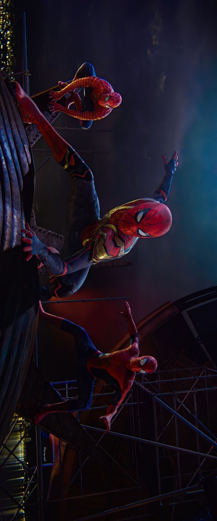 two spider - man statues are shown in the dark