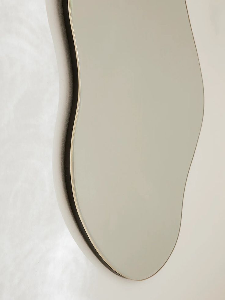 an oval shaped mirror on the wall