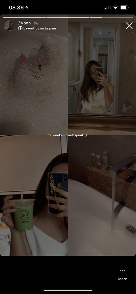 a woman taking a selfie in front of a mirror with her cell phone and coffee cup