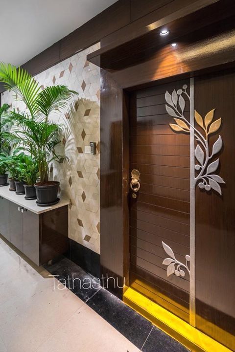 an entrance to a building with plants and potted plants on either side of the doors