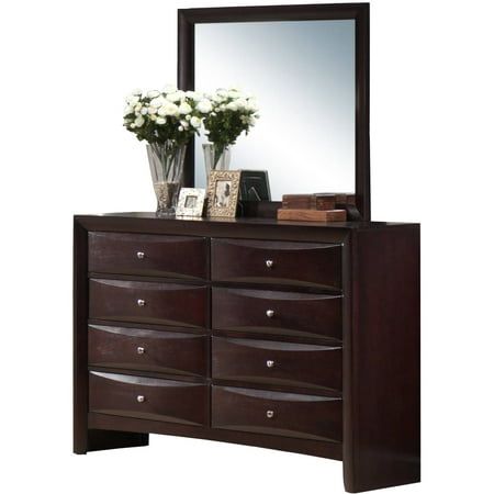 a brown dresser with flowers and a mirror