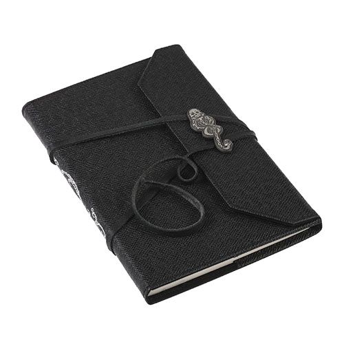 a black notebook with a metal clasp on the front and an embellishment in the middle