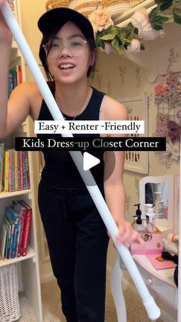 a woman holding a white plastic stick in her hand with the words easy renter - friendly kids dress up closet corner