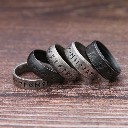 three rings with the names of different languages on them sitting on a wooden surface,