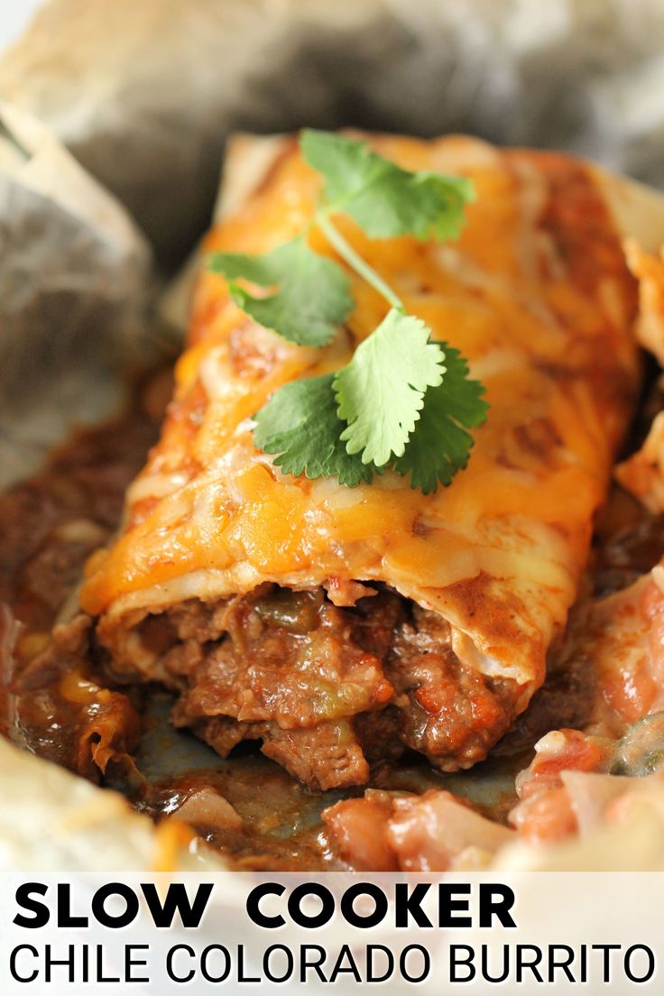 a close up of a plate of food with text overlay that reads slow cooker chili burrito