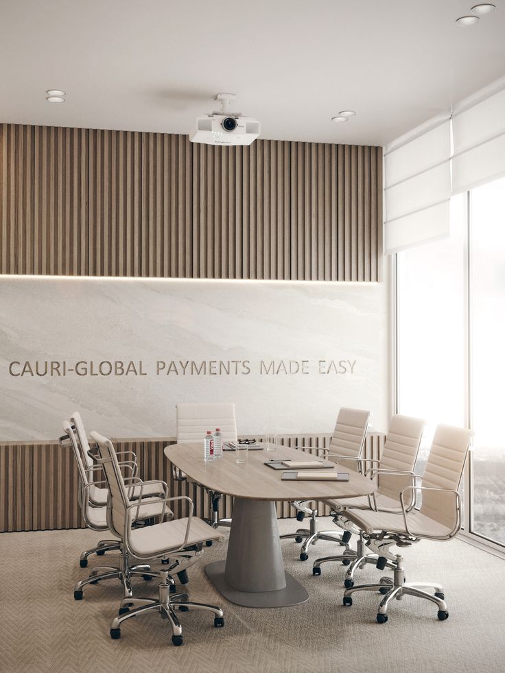 an empty conference room with chairs and a table in front of a sign that says cauri - global payments made easy