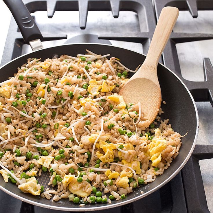 a skillet filled with rice and peas