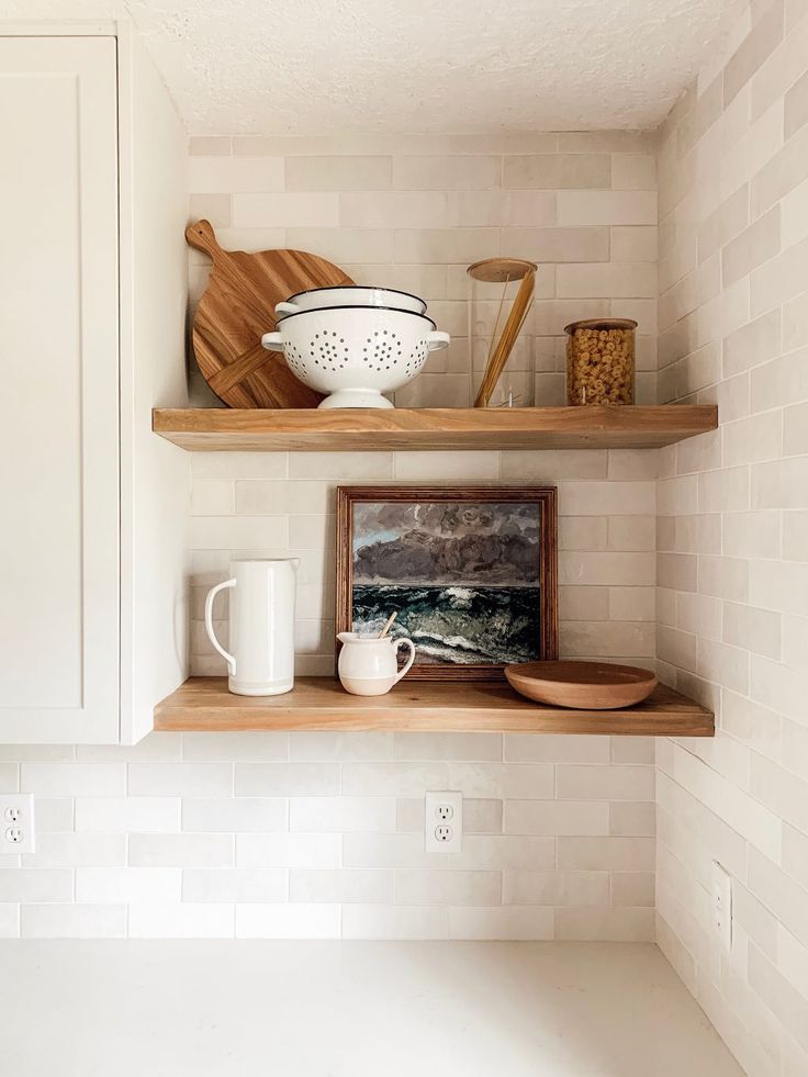 two wooden shelves in the corner of a kitchen