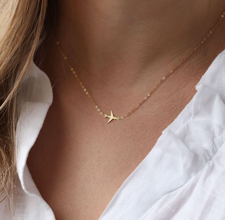 "Introducing our Airplane Necklace, a stunning tribute to the spirit of aviation. This necklace is expertly crafted with 14k Gold Fill, ensuring both durability and a touch of luxury. Designed with flight attendants and pilots in mind, it makes the perfect gift for her. This aviation-inspired necklace captures the essence of wanderlust and adventure, serving as a constant reminder of the skies above. Featuring an engraved plane charm, it adds a unique and personalized touch to your jewelry collection. Whether you're soaring through the clouds or grounded on land, this necklace is a stylish statement piece that complements any outfit. Not only does this necklace showcase impeccable craftsmanship, but it is also waterproof and non-tarnish, allowing you to wear it with confidence and ease. It Flight Attendant Jewelry, Airplane Ring Jewelry, Jet Necklace, Gold Airplane Necklace, Airplane Pendant, Airplane Jewelry, Plane Necklace, Travel Inspired Jewelry, Airplane Necklace