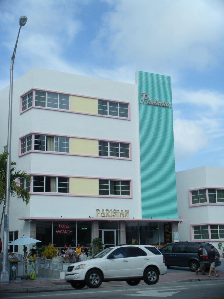 a white car parked in front of a building