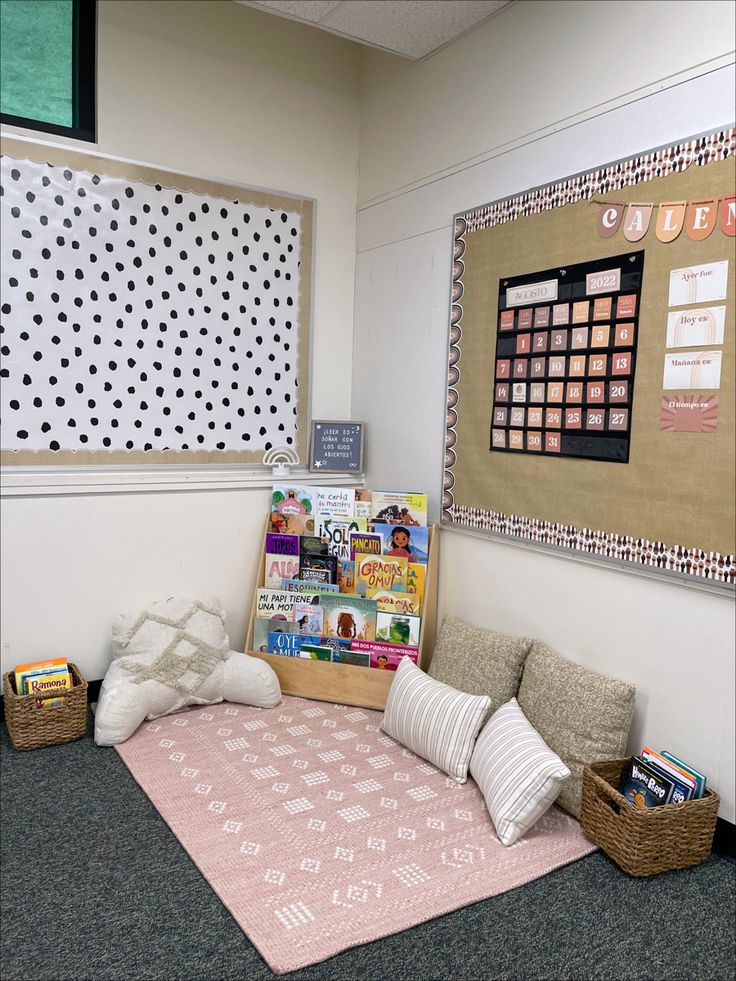 an office cubicle with bookshelves and posters on the wall, including a pink rug