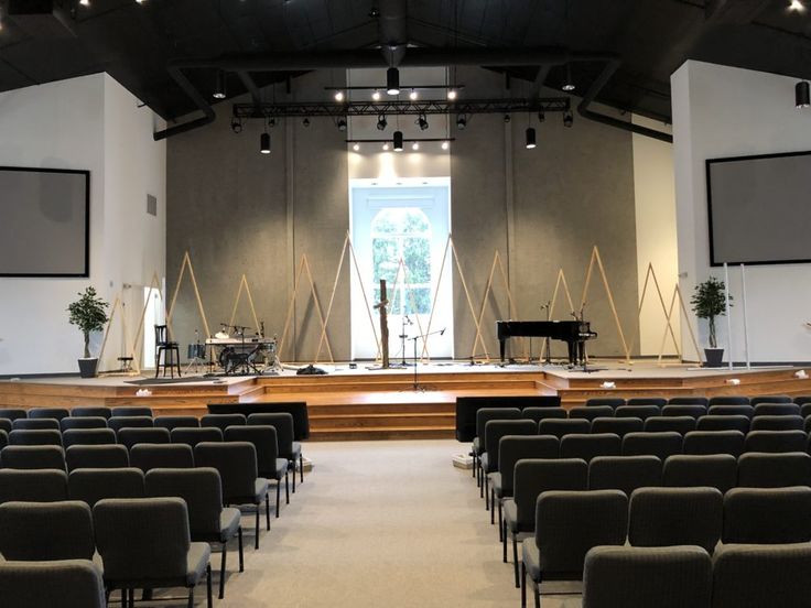 an empty church with rows of chairs facing the stage